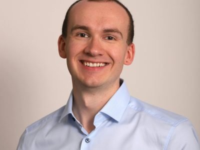 pexels-photo-29856511-29856511 A professional portrait of a smiling man in business attire, perfect for corporate use.